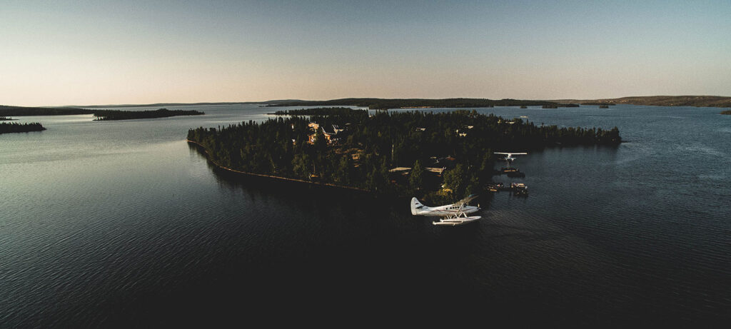 Personal plane circling a small island, inhabited island, forested island, prop planes, ocean, Rawfish Media, Baxter, MN, Minnesota marketing specialists, social media management services, photography, videography, brand development, storytelling, private island
